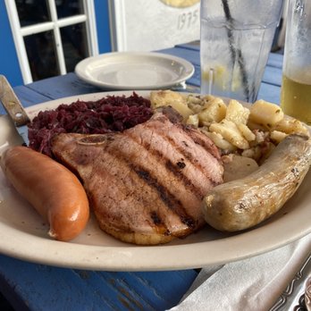The Heidelberg - Schlachtplatte with German potato salad and red cabbage. Two wursts and a smoked chop. - German Near Me - Helen, Georgia The Heidelberg - Schlachtplatte with German potato salad and red cabbage. Two wursts and a smoked chop. - German Near Me - Helen, Georgia