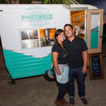 Sugar Lips Mini Donuts - a man and a woman standing in front of a food truck - Donuts Near Me Sugar Lips Mini Donuts - a man and a woman standing in front of a food truck - Donuts Near Me