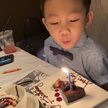 Roy's Waikiki - Birthday boy with his dessert - Hawaiian Near Me - Honolulu, Hawaii