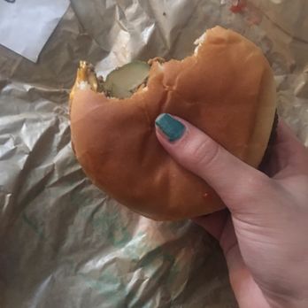 McDonald's - a hand holding a half eaten hamburger - Coffee & Tea Near Me - Chisholm, Minnesota McDonald's - a hand holding a half eaten hamburger - Coffee & Tea Near Me - Chisholm, Minnesota