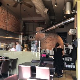 The dining room with the big red brick oven where the magic happens. The dining room with the big red brick oven where the magic happens.