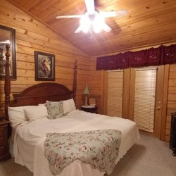 The Cabins At Grand Mountain - Messy bed because it's already been slept in. Doors lead to a small private balcony with table & chairs!