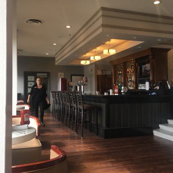 Bellamy's Lounge - a woman standing at the bar - Lounges Near Me - Edmonton, Alberta