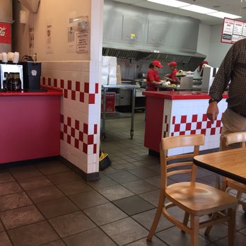 Five Guys - a man standing in a restaurant kitchen - Burgers Near Me - Pinellas Park, Florida Five Guys - a man standing in a restaurant kitchen - Burgers Near Me - Pinellas Park, Florida