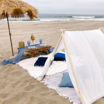 Wndrlnd Picnics - Our costal theme, tiki umbrella and boho tent are perfect for beach days. - Party & Event Planning Near Me Wndrlnd Picnics - Our costal theme, tiki umbrella and boho tent are perfect for beach days. - Party & Event Planning Near Me