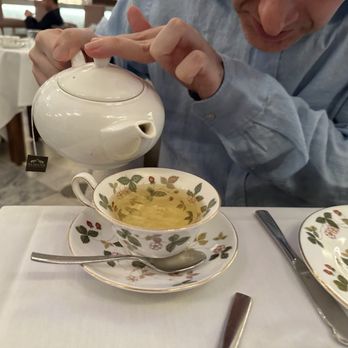 Afternoon Tea - a woman pouring tea into a cup - Tea Rooms Near Me - Montreal, Quebec