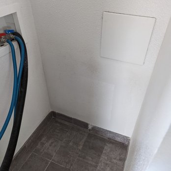 Hi End Builders - a bathroom with a drain - Drywall Installation & Repair Near Me