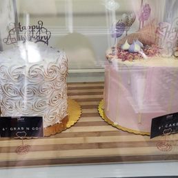 Examples of their cakes in their display. Examples of their cakes in their display.
