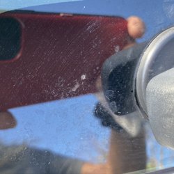 Shell - Back window of hatchback - dirty - tried to wipe some off and reflection