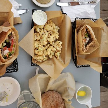 Oren's Hummus - Happy hour spread. Half falafel n beef sammi.roasted Cauliflower.  Baba ganoush. Fluffy pillowy pita bread. - Mediterranean Near Me - Cupertino, California
