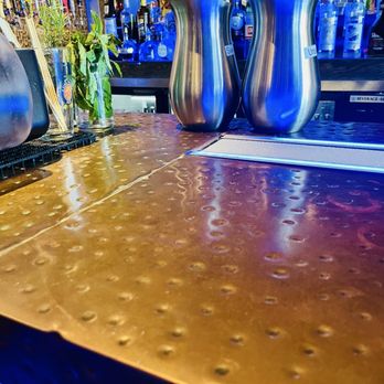 Ford's Garage Gainesville - Hammered copper countertop with embedded white sand bar for drinks - Burgers Near Me - Gainesville, Florida Ford's Garage Gainesville - Hammered copper countertop with embedded white sand bar for drinks - Burgers Near Me - Gainesville, Florida