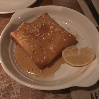 Kiki's - Saganaki. Pan seared crispy phyllo sesame crusted dough with kefalograviera cheese served with honey and lemon. 'Nuff said! - Greek Near Me - New York, New York