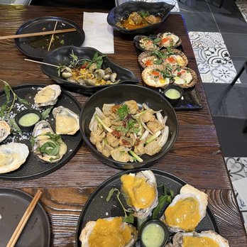 HEM Kitchen And Bar - Whole spread (salted egg + cheese oysters, salt/pepper squid, moon snail, scallops, balut) - Vietnamese Near Me - Houston, Texas