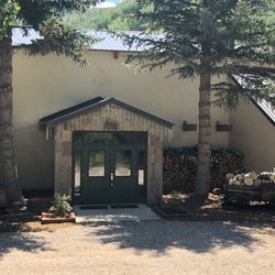 Sunlight Lodge Bed & Breakfast - Front Entrance.  An old mine cart and logging wagon outside give you an idea of the rich history the area has.
