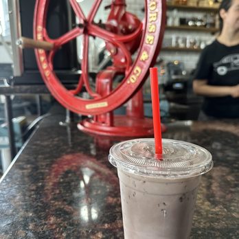 Global Coffee - a cup of iced coffee with a straw - Coffee & Tea Near Me - El Paso, Texas