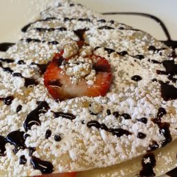 a crepe with strawberries and powdered sugar