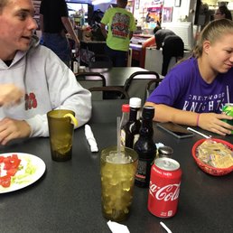 a couple of people eating at a table a couple of people eating at a table