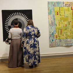 Schweinfurth Art Center - Visitors take a close look at Audrey Esarey's "Repelling Radial," one of 69 pieces in "Quilts=Art=Quilts 2022" at Schweinfurth Art Center.