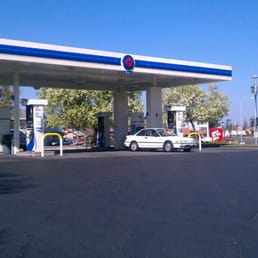 a gas station with cars parked in front of it