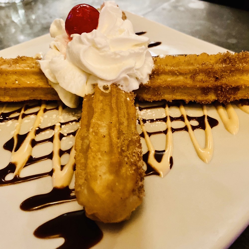 Fresco's Cantina - Mini Churros Cinnamon-sugar tossed churros filled with "Cajeta" Mexican caramel served with nutella and chocolate sauce for dipping. - Mexican Near Me - Astoria, New York Fresco's Cantina - Mini Churros Cinnamon-sugar tossed churros filled with "Cajeta" Mexican caramel served with nutella and chocolate sauce for dipping. - Mexican Near Me - Astoria, New York