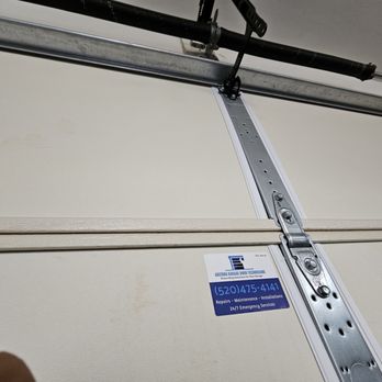 Arizona Garage Door Technicians - Main door spring with handy reminder sticker, showing a workman's pride! - Garage Door Services Near Me - Oro Valley, Arizona Arizona Garage Door Technicians - Main door spring with handy reminder sticker, showing a workman's pride! - Garage Door Services Near Me - Oro Valley, Arizona