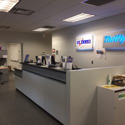 Thrifty Rent A Car - There's about 2 inches between the counter and the door and people's desks right next to the counter.