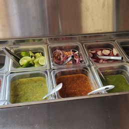salsa Bar. The salsa on the far left is for chips. And starting from the left side is mild to spicy.