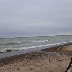 Lakefront view of crashing waves on a blustery and overcast March day