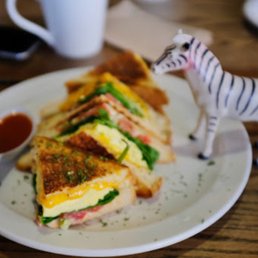 a plate with a sandwich and a toy zebra a plate with a sandwich and a toy zebra