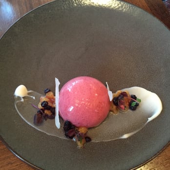 NoMI - Huckleberry mousse bombe with a Meyer lemon puree core, coriander financier, coconut gel, candied coconut, and caramelized pear - Bars Near Me - Chicago, Illinois