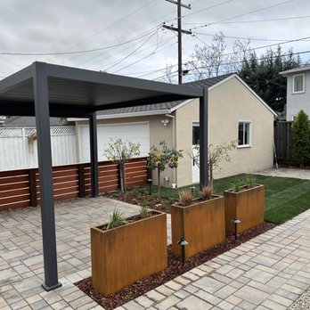 Total Landscape - a backyard with a pergol roof - Landscaping Near Me Total Landscape - a backyard with a pergol roof - Landscaping Near Me