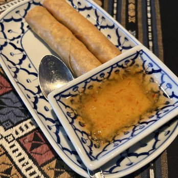 Thai Orchid Cuisine - a bowl of dipping sauce and two spring rolls - Thai Near Me - Mount Clemens, Michigan Thai Orchid Cuisine - a bowl of dipping sauce and two spring rolls - Thai Near Me - Mount Clemens, Michigan