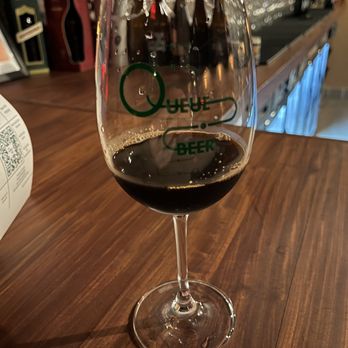 Queue Beer - a glass of wine on a bar - Beer Bar Near Me - Brooklyn, New York