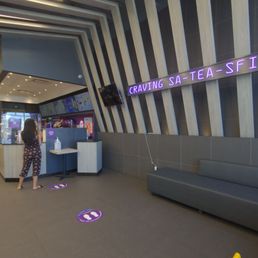a woman standing in the lobby of a restaurant