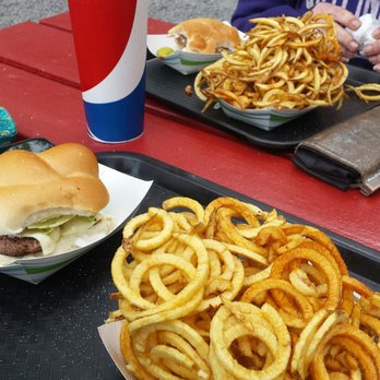 Serious Food - a woman sitting at a picnic table - Fast Food Near Me - Livonia, New York Serious Food - a woman sitting at a picnic table - Fast Food Near Me - Livonia, New York