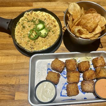Topgolf - Kickin' popper dip served with kettle chips. Cheesy macaroni bites with ranch and creamy tomato sauce. - New American Near Me - West Chester Township, Ohio Topgolf - Kickin' popper dip served with kettle chips. Cheesy macaroni bites with ranch and creamy tomato sauce. - New American Near Me - West Chester Township, Ohio