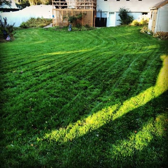 RedZone Landscaping - a green lawn and a house - Landscaping Near Me