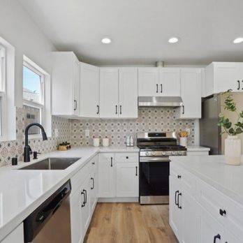 RPD Construction - a kitchen with white cabinets and stainless steel appliances - General Contractors Near Me RPD Construction - a kitchen with white cabinets and stainless steel appliances - General Contractors Near Me