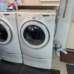 VSH Appliance Repair - Whirlpool Duet front-load washer and dryer on pedestals in a garage