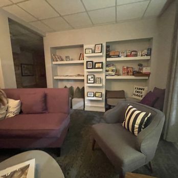Grape Water Wine Bar - a woman sitting on a couch - Wine Bars Near Me - Middleton, Wisconsin