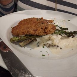 Fried pork chops and asparagus over mashed potatoes and gravy Fried pork chops and asparagus over mashed potatoes and gravy