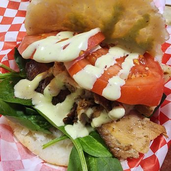 Arepa Venezuelan Kitchen - Bellevue - Miss Piggy #6 Signature pork, cilantro sauce,  tomatoes and spinach - Empanadas Near Me - Bellevue, Washington