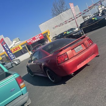 Shell - a red sports car parked in a parking lot - Gas Stations Near Me - Oakdale, California