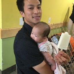 Paleta in one hand, baby in the other