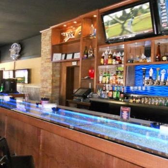 The Back 9 Sports Bar & Grill - a bar with several televisions on the wall - American Near Me - Addison, Texas The Back 9 Sports Bar & Grill - a bar with several televisions on the wall - American Near Me - Addison, Texas