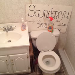 Saundarya Beauty Parlor - A flimsy sign on top of the toilet, for what? The floor is filthy.