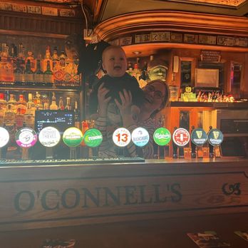 O'Connells - When they found out he was the tiniest O'Connell visiting, he got a complementary pic behind the O'Connell's engraved bar mount! - Irish Pub Near Me - Dublin, D