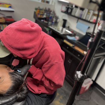 Landmark Tattoo - Josh inking up the side of the face and ear - Tattoo Near Me