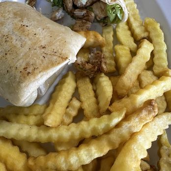 Maria's Cafe - Grilled Chicken Caesar wrap served with another generous side of fries. - Breakfast & Brunch Near Me - Stuart, Florida