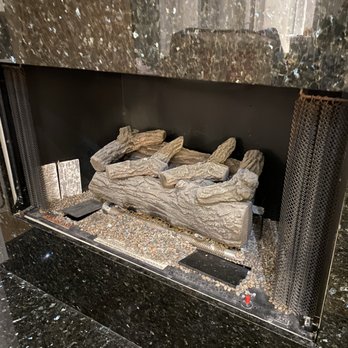 Dean Russell Custom Homes - Fireplace with broken glass pieces that can be seen if looking at stones carefully - General Contractors Near Me - Jacksonville Beach, Florida